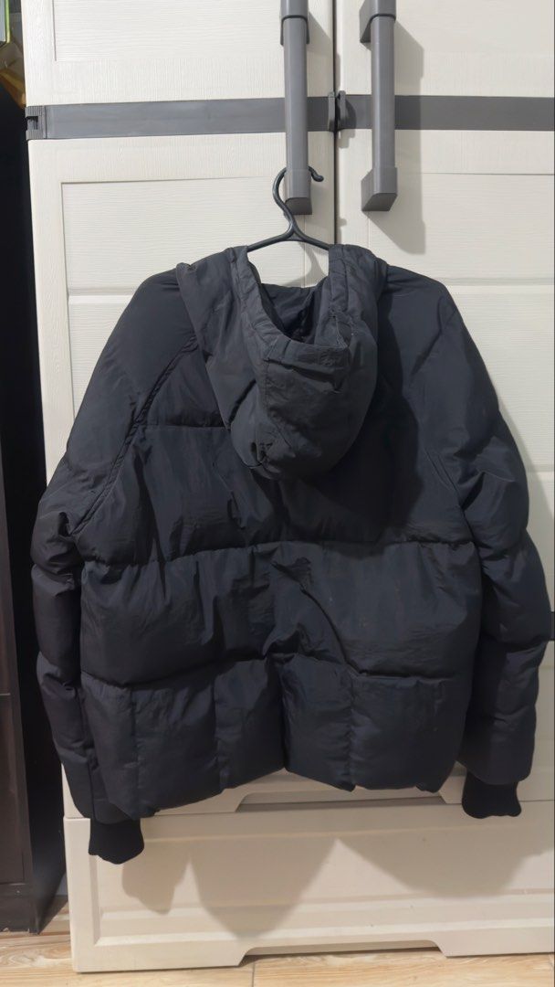 Black Hooded Puffer Jacket (Category: Coats, Jackets and Outerwear) located in Bulacan. Submitted by jenelynichole (Listing ID 1463674200, Image 2). Description: - Cozy black puffer jacket - Features a warm hood - Ribbed cuffs for a snug fit - Ideal for colder weather - Versatile and easy to style - Pre-loved and ready for its next adventure.