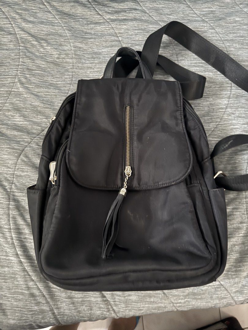 Black Nylon Backpack with Tassel Detail (Category: Backpacks) located in Las Pinas. Submitted by megalleon8 (Listing ID 1463573091, Image 2). Description: - Stylish black nylon backpack - Front zip pocket with a cute tassel charm - Wide-opening main compartment for easy access - Interior pockets for organized storage - Comfortable adjustable shoulder straps - Ideal for everyday errands or your next adventure.