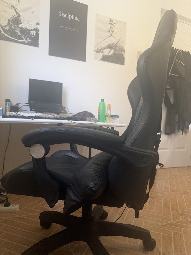 Black PU Leather Gaming Chair with Lumbar Support (Category: Chairs) located in Marikina City. Submitted by pong15 (Listing ID 1463612491, Image 2). Description: - Black PU leather gaming chair - Adjustable lumbar and neck pillows for comfort - Reclining backrest for relaxation - Smooth-rolling wheels for easy mobility - Perfect for long gaming sessions or office work - Hydraulic not working but repairable.