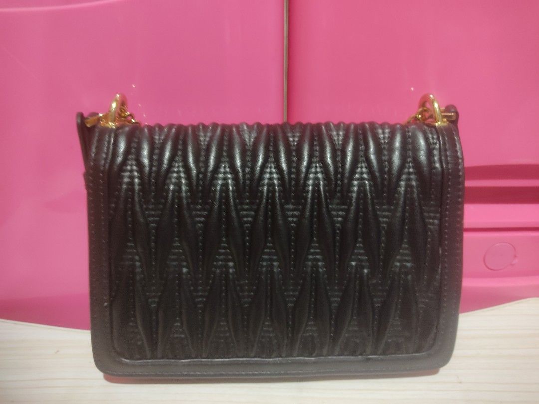 Black Quilted Chain Bag with Gold Clasp (Category: Luxury Bags & Wallets) located in Manila. Submitted by xiaochao.16 (Listing ID 1463738349, Image 3). Description: - Black quilted handbag - Gold chain strap - Decorative gold clasp closure - Interior zippered pocket - Main compartment - Ideal for evening wear or adding flair to any outfit.