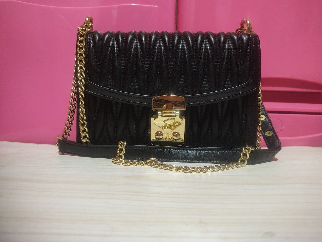 Black Quilted Chain Bag with Gold Clasp (Category: Luxury Bags & Wallets) located in Manila. Submitted by xiaochao.16 (Listing ID 1463738349, Image 1). Description: - Black quilted handbag - Gold chain strap - Decorative gold clasp closure - Interior zippered pocket - Main compartment - Ideal for evening wear or adding flair to any outfit.