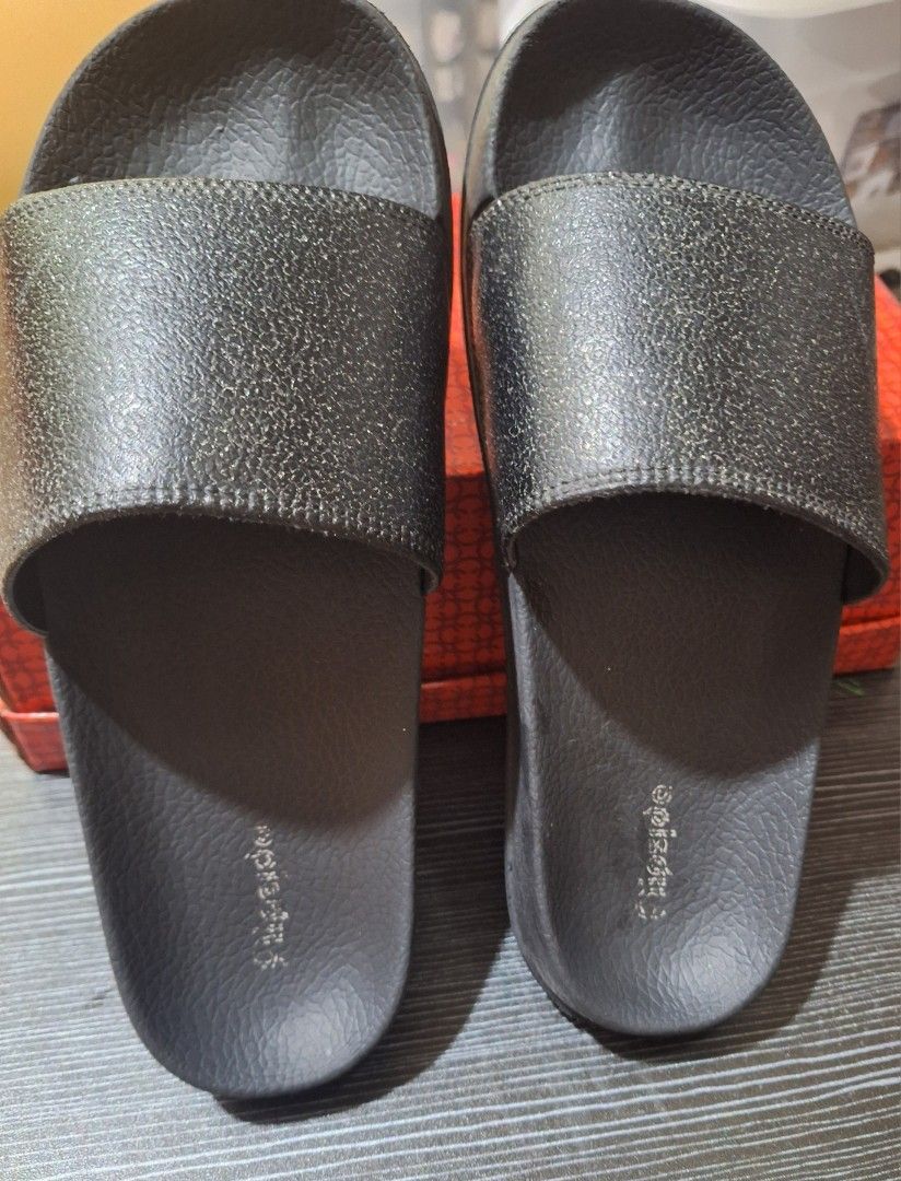 Black Slides with Metallic grains strap Size 38 (Category: Slippers and slides) located in Quezon City. Submitted by gnew024102 (Listing ID 1463598187, Image 1). Description: - Classic black slides - Simple and timeless design - Textured sole for enhanced grip - Wide, comfortable strap - Easy slip-on and off - Ideal for casual outings or lounging at home.