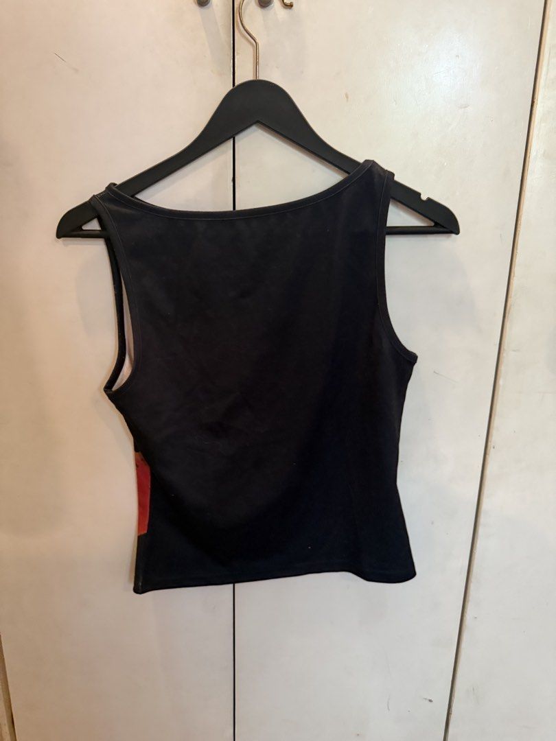 Black Tank Top with Red Floral Print (Category: Sleeveless) located in Manila. Submitted by andromedanny (Listing ID 1463610019, Image 2). Description: - Black sleeveless tank top - Features a bold red and brown floral graphic on the front - Simple scoop neckline - Ideal for casual wear - Easily pairs with jeans or shorts - RFS: Decluttering.