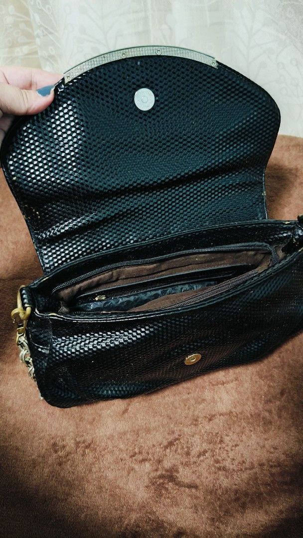 Black Textured Shoulder Bag with Chain Strap (Category: Shoulder Bags) located in Manila. Submitted by serenitycarlylle (Listing ID 1463725362, Image 3). Description: - Stylish black shoulder bag - Textured finish for a sophisticated look - Versatile chain and faux leather strap - Convenient interior zip pocket and main compartment - Handy exterior back zip pocket - Secure magnetic snap closure - Ideal size for carrying your essentials.
