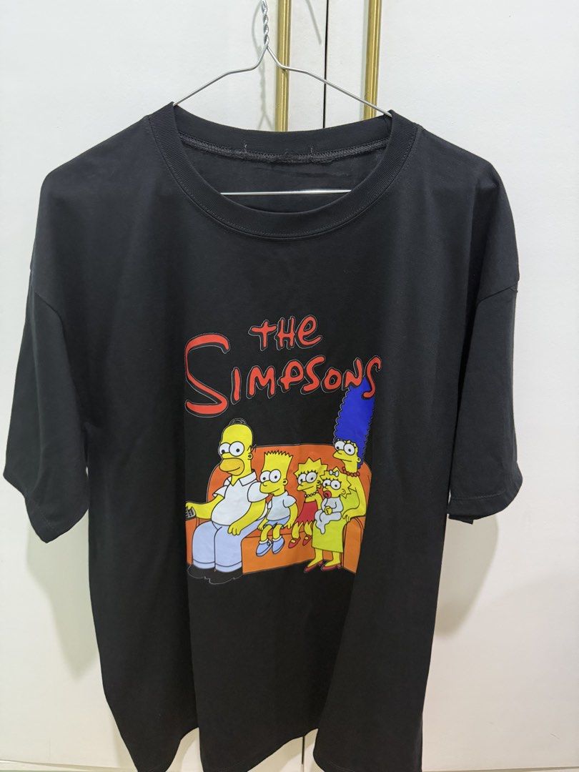 Black The Simpsons T-shirt (Category: Tshirts & Polo Shirts ) located in Quezon City. Submitted by pamelasal51714 (Listing ID 1463574202, Image 1). Description: - Classic black t-shirt - Features The Simpsons family (Homer, Marge, Bart, Lisa, Maggie) graphic print - Design shows the family on the couch - Comfortable crew neck - Short sleeves - Ideal for any Simpsons fan.