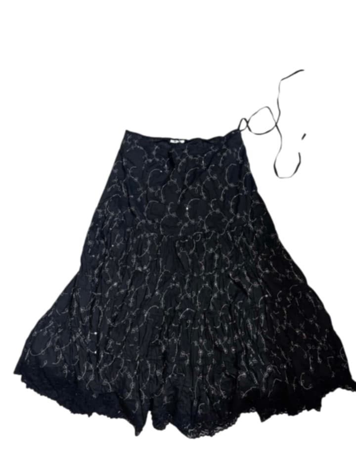 Black Tiered Maxi Skirt with White Swirl Pattern (Category: Skirts) located in Manila. Submitted by fastforest_65f95b (Listing ID 1463665346, Image 1). Description: - Flowy black maxi skirt - Delicate white swirl pattern all over - Tiered design with lace trim at the hem - Features a tie detail at the waist - Perfect for casual or dressy occasions.