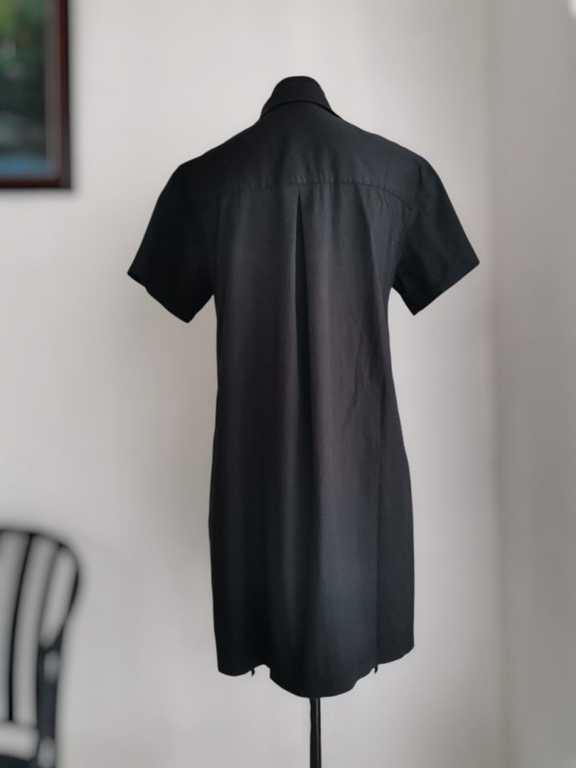 Black Button-down Shirt Dress (Med-Large) (Category: Dresses) located in Quezon City. Submitted by engeleaize (Listing ID 1463602900, Image 2). Description: Details: Color: All black, 9/10 color rate Style: Avant-Garde style minimalist shirt dress, structured collar, short sleeves, chest yoke, button-down, trailing fabric straps with dangling ties at the hem Fabric: Cotton-nylon-spandex blend Best worn: Casual streetwear, creative workplace, gall