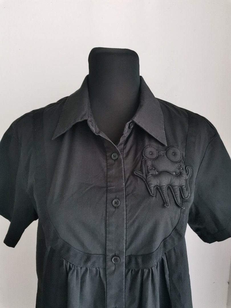 Black Button-down Shirt Dress (Med-Large) (Category: Dresses) located in Quezon City. Submitted by engeleaize (Listing ID 1463602900, Image 3). Description: Details: Color: All black, 9/10 color rate Style: Avant-Garde style minimalist shirt dress, structured collar, short sleeves, chest yoke, button-down, trailing fabric straps with dangling ties at the hem Fabric: Cotton-nylon-spandex blend Best worn: Casual streetwear, creative workplace, gall