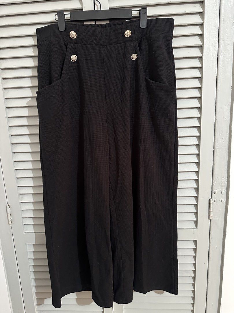 Black Wide Leg Pants with Gold Buttons (Category: Other Bottoms) located in Subic. Submitted by ruffa_assorted_item (Listing ID 1463632606, Image 1). Description: - Can fit up to XL - Black wide leg pants - Elastic waistband at the back for comfort - Two decorative gold buttons on the front - Functional pockets - Textured fabric - Versatile for casual or dressy looks.