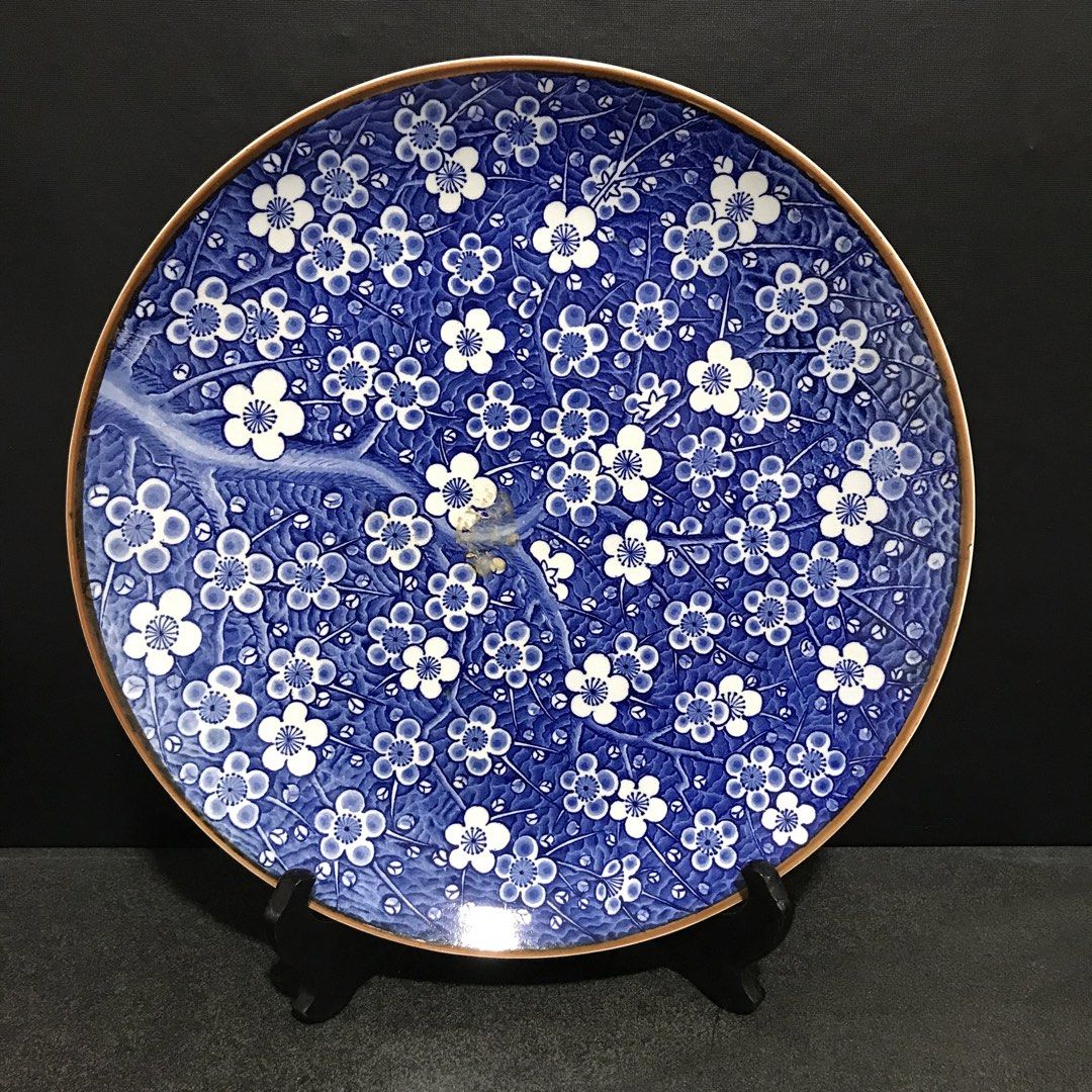 Blue & White Floral Ceramic Decorative Plate (Category: Dinnerware & Cutlery) located in Baao. Submitted by all.things.japan (Listing ID 1463586842, Image 1). Description: 12.25 inches diameter 1.5 inches height - Stunning blue and white ceramic plate - Features an intricate all-over floral pattern - Subtle brown accent on the rim - Ideal for decorative display or as a unique serving dish - Approximate dimensions: [insert size here if known] - A 