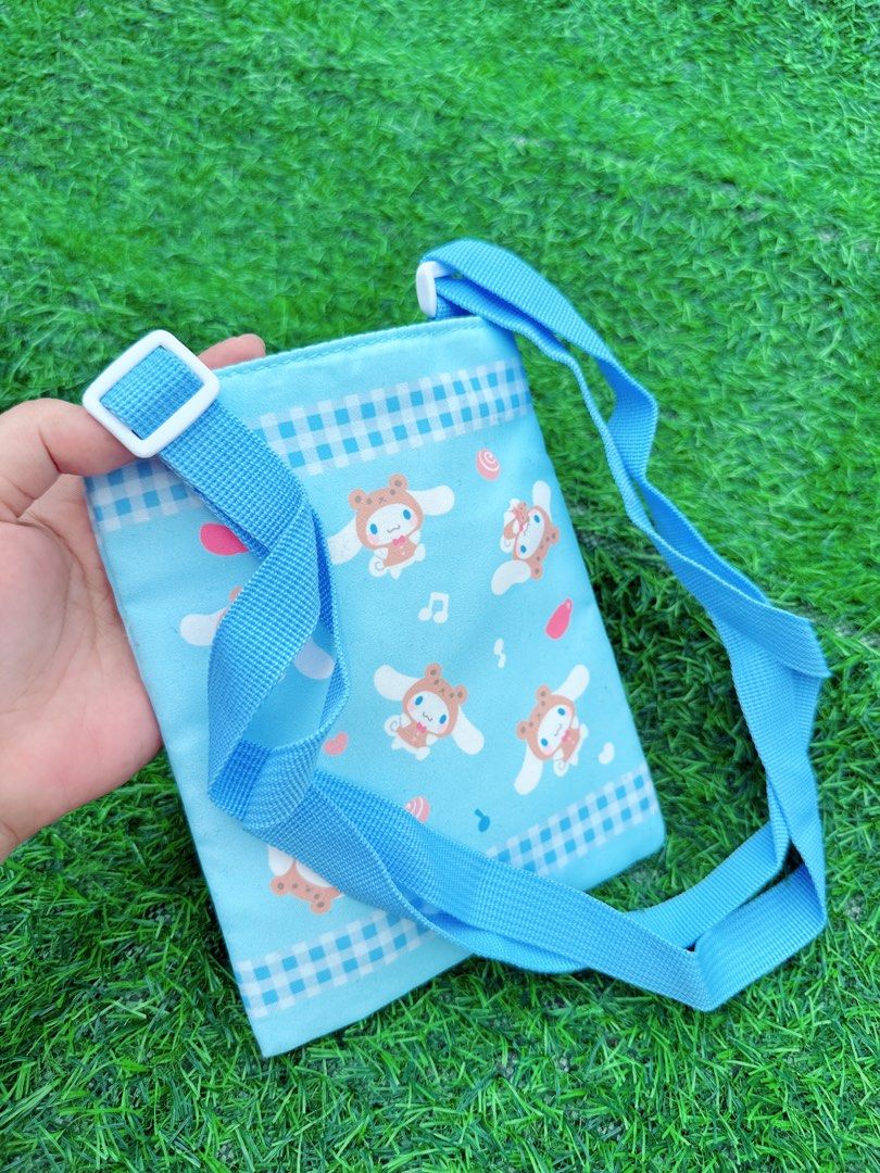 Blue Cinnamoroll Crossbody Bag with Adjustable Strap (Category: Cross-body Bags) located in Manila. Submitted by ronoarabbit.ph (Listing ID 1463669075, Image 2). Description: - Adorable blue crossbody bag featuring Cinnamoroll - Stylish checkered pattern trim - Adjustable strap with buckle for a comfortable fit - Interior features a couple of small pockets for organization - Secure velcro closure - Ideal for carrying your daily essentials 📌Payme