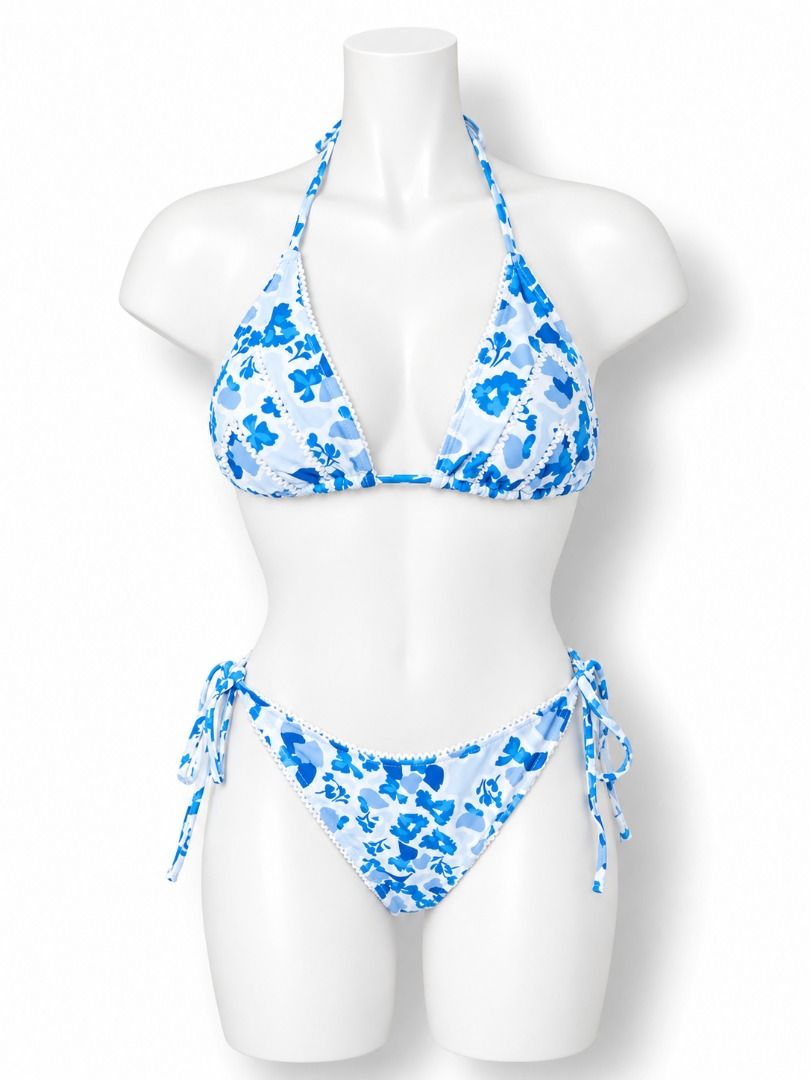 Blue Floral Halter Bikini with Tie Sides (Category: Bikinis & Swimsuits) located in Caloocan City. Submitted by eunje (Listing ID 1463692688, Image 1). Description: - Adorable blue floral bikini set - Halter top design - Adjustable tie sides on bottoms for a perfect fit - Features a subtle white trim along the edges - Ideal for beach days, pool parties, or your next vacation getaway.