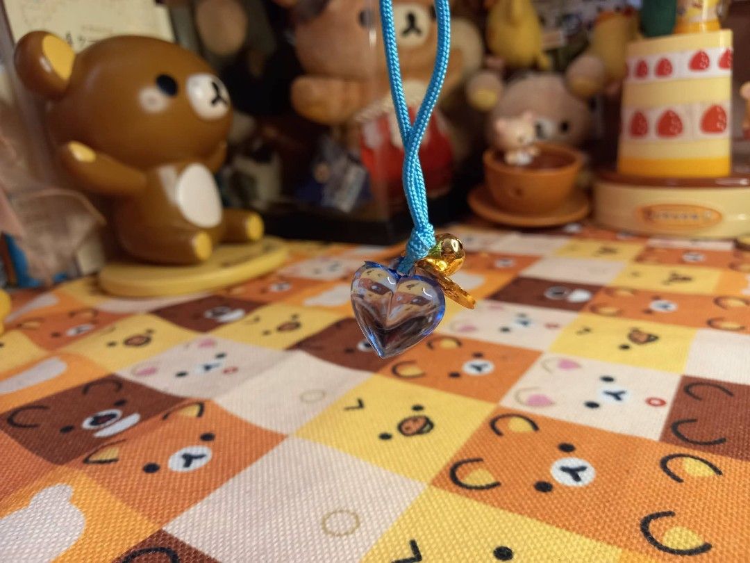 Blue Heart Charm Necklace with Bell (Category: Necklaces) located in Bulacan. Submitted by arax_kumashop (Listing ID 1463694468, Image 2). Description: - Adorable blue heart charm necklace - Features a tiny bell and a gold-colored coin charm - Strung on a vibrant bright blue cord - Adds a cute and fun touch to any outfit - Ideal as a playful accessory.