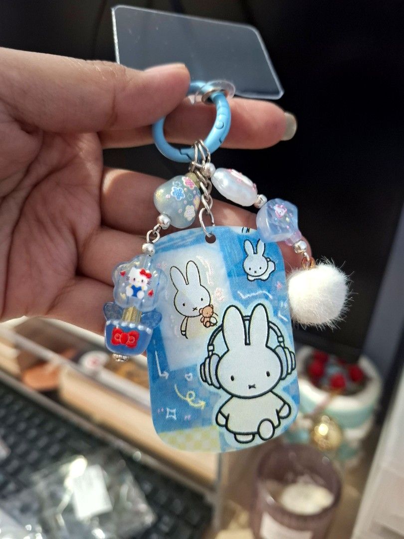 Blue Miffy Hello Kitty Phone Charm (Category: Character Goods) located in Quezon City. Submitted by an.marie (Listing ID 1463632874, Image 1). Description: Super cute Miffy & Kitty keychain charm with colorful beads and a fluffy pom pom. Attaches with a blue ring. Perfect for phone, bags or keys!.