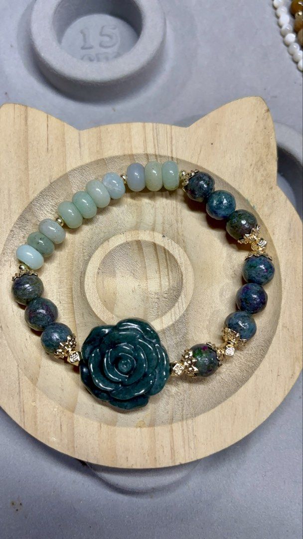 Blue Water Jade + Ruby Sapphire Bracelet with Rose Charm (Category: Bracelets) located in Rizal. Submitted by va_nes_sa_ (Listing ID 1463632883, Image 2). Description: - Stunning bracelet featuring blue water jade and ruby sapphire beads. - Adorned with a beautiful dark green rose charm at the center. - Elegant gold-tone accents for a sparkling touch. - Believed to promote peace, good fortune, protection, confidence, and emotional balance. - Comf