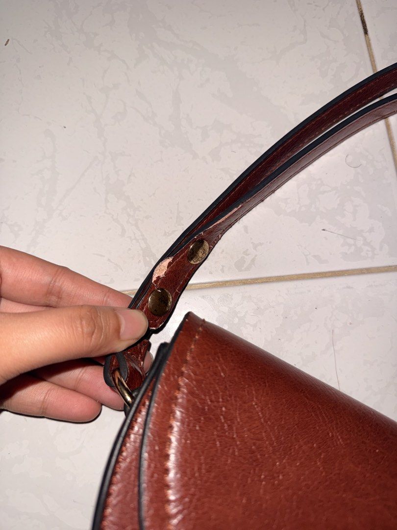 Brown Mango Shoulder Bag (Category: Shoulder Bags) located in Lucena. Submitted by lcndeclutter (Listing ID 1463656808, Image 2). Description: - Mango brown shoulder bag (can also be used as sling bag) - Curved shape with gold clasp closure - Strap shows wear and tear (peeling edges) - Black fabric interior - Perfect for everyday use.