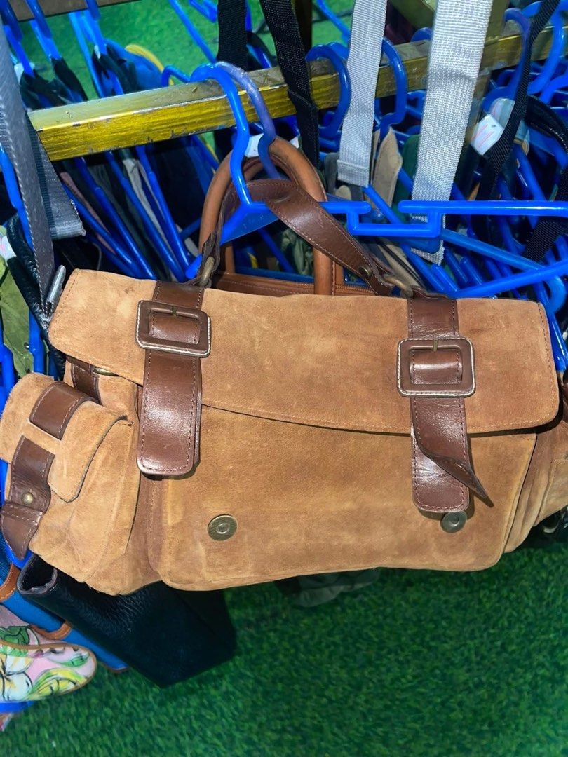 Brown Suede Leather Handbag with Buckle Straps (Category: Luxury Bags & Wallets) located in La Trinidad. Submitted by potatothriftlip (Listing ID 1463683579, Image 1). Description: - Chic brown suede leather handbag - Messenger bag style - Features leather straps with front buckles - Two side pockets with buckle closures - Convenient top handle for carrying - Ideal for everyday use.