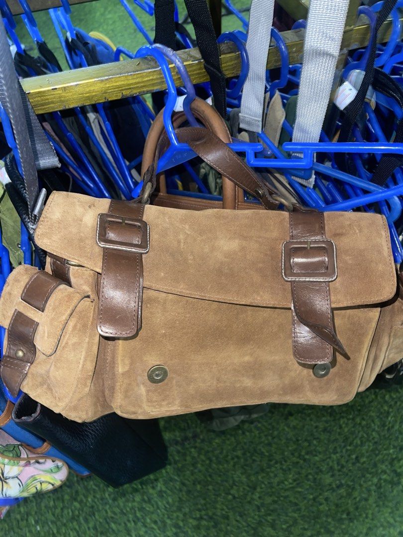 Brown Suede Leather Handbag with Buckle Straps (Category: Luxury Bags & Wallets) located in La Trinidad. Submitted by potatothriftlip (Listing ID 1463683579, Image 2). Description: - Chic brown suede leather handbag - Messenger bag style - Features leather straps with front buckles - Two side pockets with buckle closures - Convenient top handle for carrying - Ideal for everyday use.