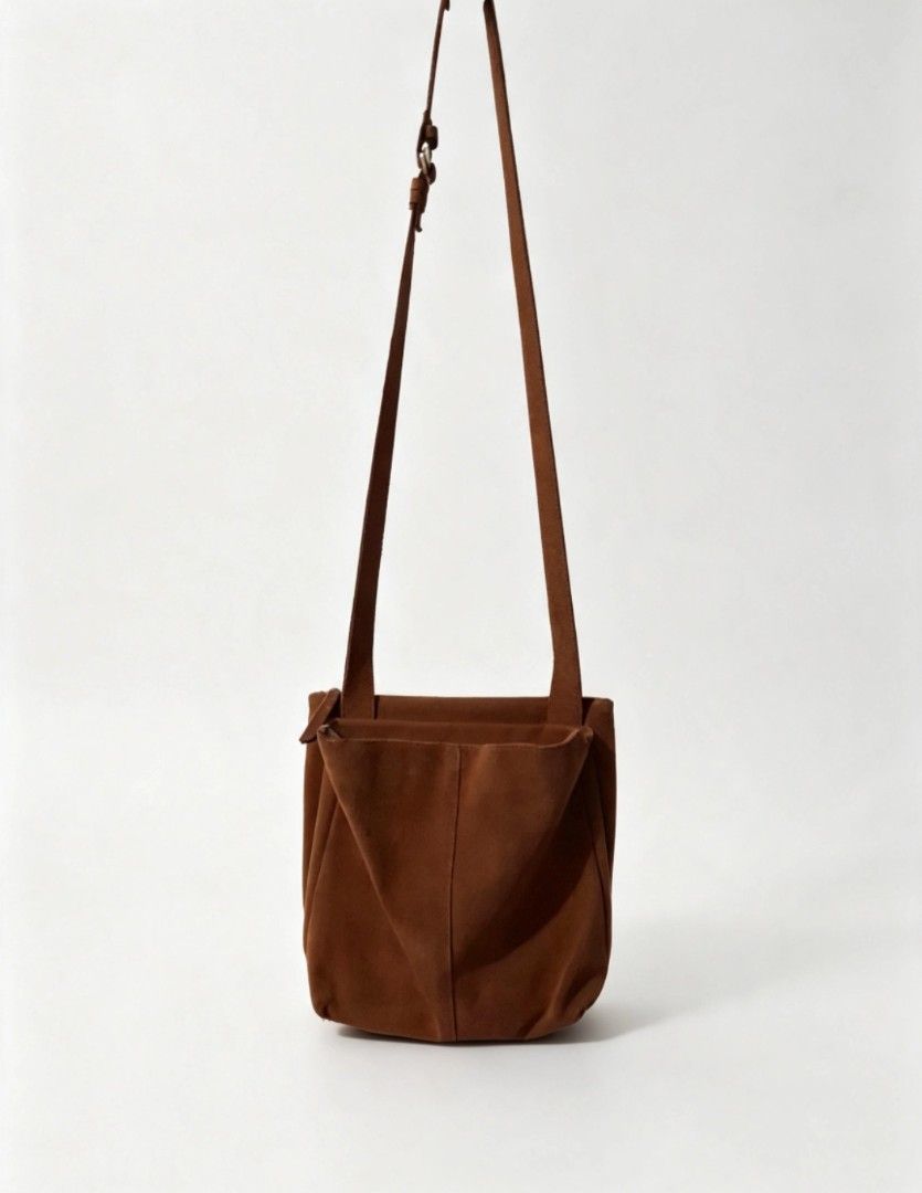Brown Suede Shoulder Bag with Zipper Closure (Category: Shoulder Bags) located in Angeles City. Submitted by anneps (Listing ID 1463651970, Image 1). Description: - Soft brown suede shoulder bag - Zipper closure across the top - Interior tag: 'ithinkso' - Adjustable strap - Great for everyday use - Plenty of space inside.