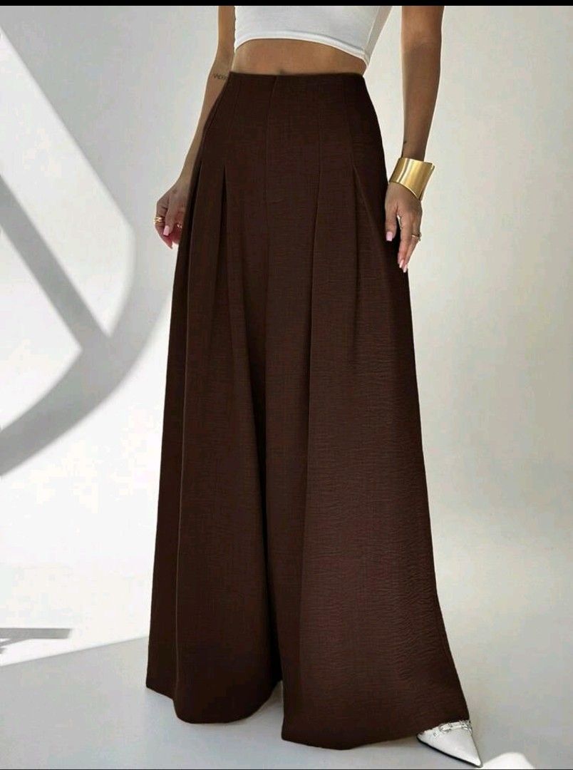Brown Wide Leg Pleated Pants (Category: Trousers) located in Manila. Submitted by allisonhope (Listing ID 1463721286, Image 1). Description: - High-waisted brown pants - Wide leg silhouette - Front pleats for a structured look - Subtle textured fabric - Comfortable and stylish - Versatile for dressing up or down.