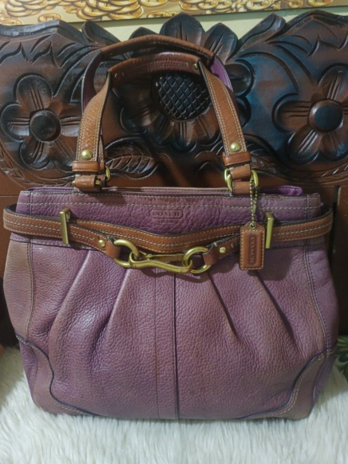 Bundled Coach Leather Handbag Purple (Category: Luxury Bags & Wallets) located in Cebu City. Submitted by elen30abalo (Listing ID 1462990500, Image 1). Description: - Purple Coach handbag - Made from luxurious full-grain cowhide leather - Stylish brown leather handles - Elegant gold hardware - Spacious interior with multiple compartments - Trendy slouchy silhouette - Crafted in China - Serial Number: NP-F0873-12476.