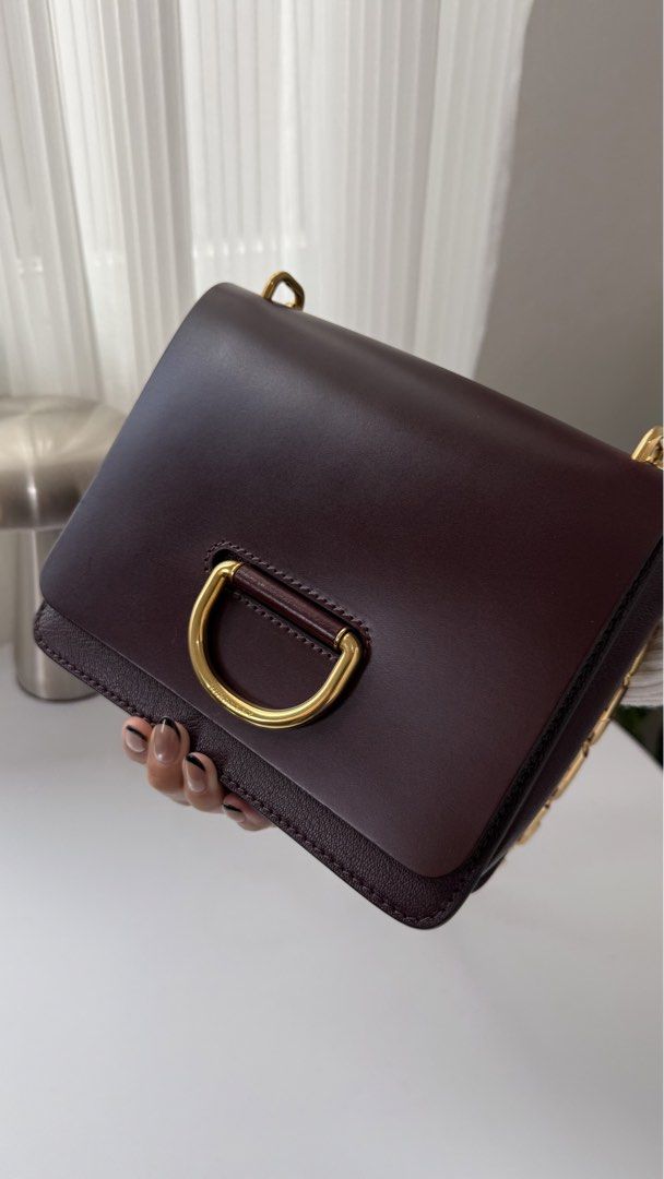 Burberry D-Ring Leather Crossbody Bag (Category: Luxury Bags & Wallets) located in General Trias. Submitted by lexluxebizz (Listing ID 1463613289, Image 3). Description: Burberry D-Ring Leather Crossbody Bag Made in Italy. (Original Price: Php 165,000++) THE DETAILS Highlights - Leather - Fold -over top - Flip-lock fastening - Partitioned compartment - Internal patch pockets - Gold-tone Hardware - Condition: EXCELLENT, like NEW. This previously o