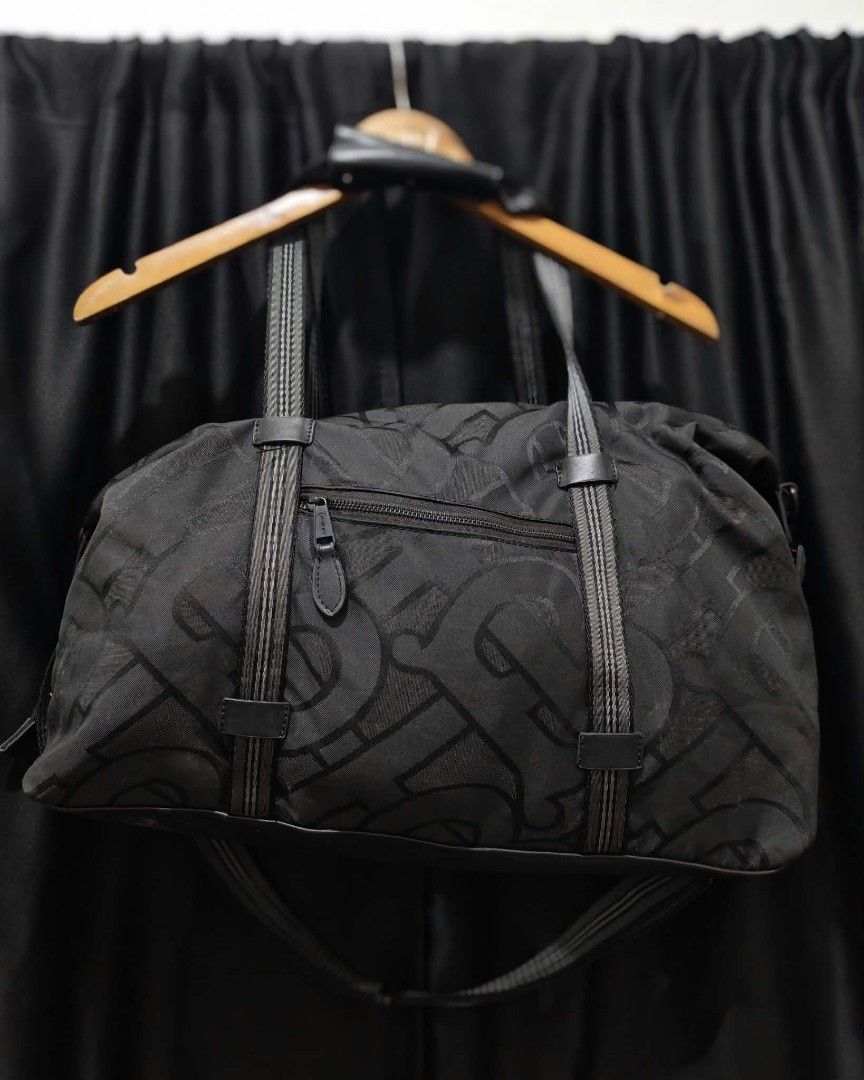 Burberry Monogram Duffel Bag (Category: Luxury Bags & Wallets) located in Baguio. Submitted by solo_ukay (Listing ID 1463694671, Image 2). Description: - Authentic Burberry duffel bag - All-over signature monogram print - Secure zip closure - Comfortable dual top handles - Detachable shoulder strap for versatile carrying - Durable blend of nylon and polyamide material - Ideal for travel, gym, or everyday use.