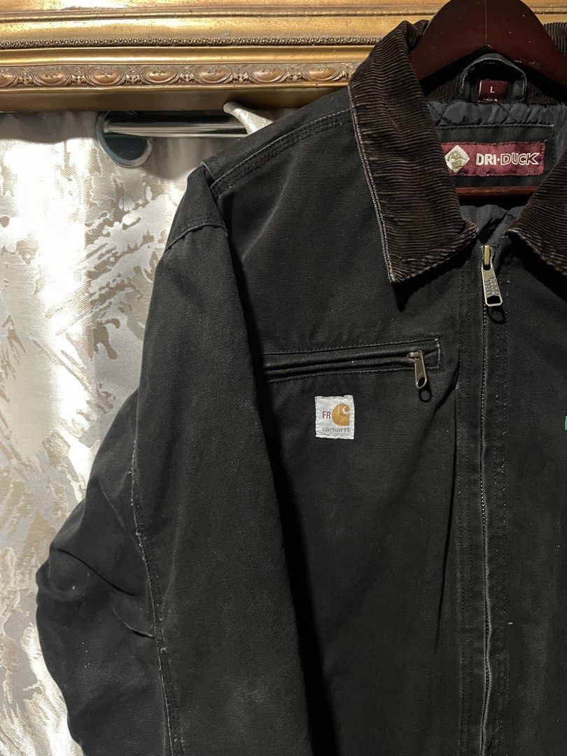 Carhartt Dri-Duck Work Jacket - Black - Size L (Category: Coats, Jackets and Outerwear) located in Bauan. Submitted by thrift.enough (Listing ID 1463688347, Image 3). Description: - Classic black Carhartt work jacket - Comfortable corduroy collar - Embroidered Sky Renewable Energy logo on chest - Secure zippered chest pocket - Two spacious hand pockets - Made with durable canvas material - Versatile for work or everyday casual wear.