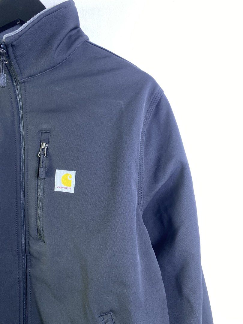 Carhartt Softshell Jacket with Amazon Logo (Category: Coats, Jackets and Outerwear) located in Manila. Submitted by declutterpromax (Listing ID 1463606144, Image 3). Description: - Dark navy Carhartt softshell jacket - Features Carhartt logo on chest - Includes embroidered Amazon logo on left chest - Multiple zippered pockets for secure storage - Versatile for work or casual wear - All zippers function smoothly.
