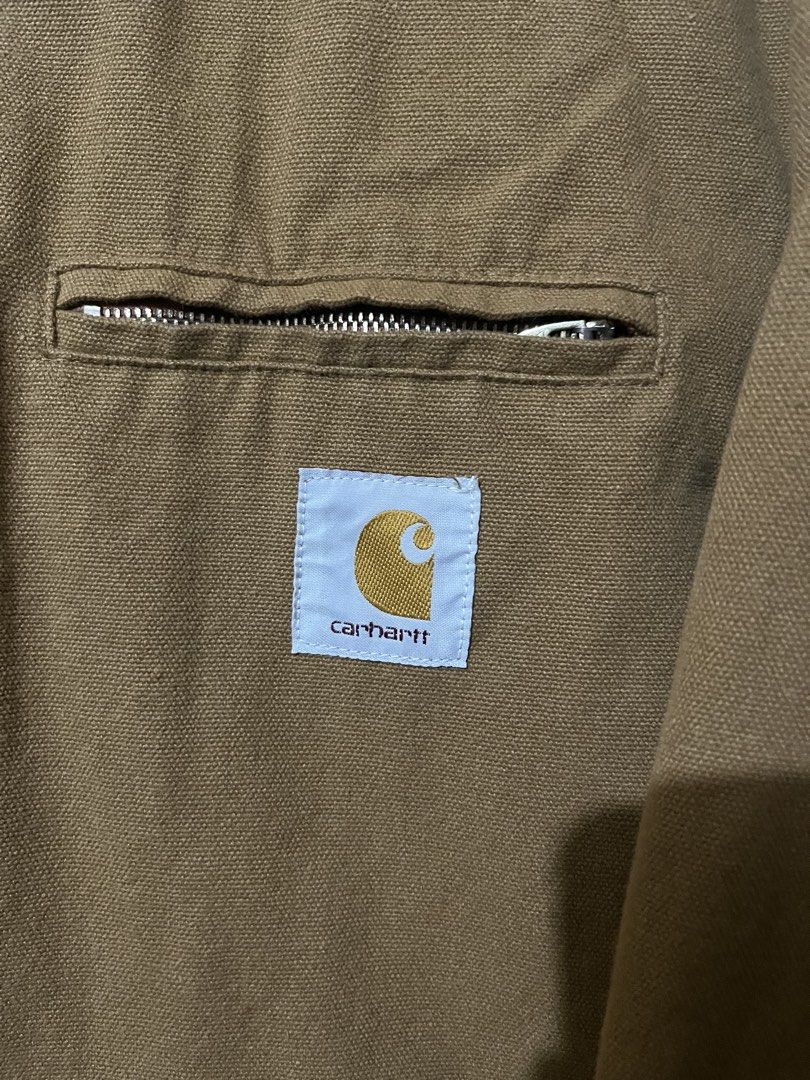 Carhartt WIP Detroit Jacket (Category: Coats, Jackets and Outerwear) located in Baguio. Submitted by visentovi (Listing ID 1463631765, Image 2). Description: - Classic tan Carhartt jacket - Features a corduroy collar - Zip-up front with button closure - Chest pocket with zip and iconic Carhartt logo patch - Durable and stylish for everyday wear.