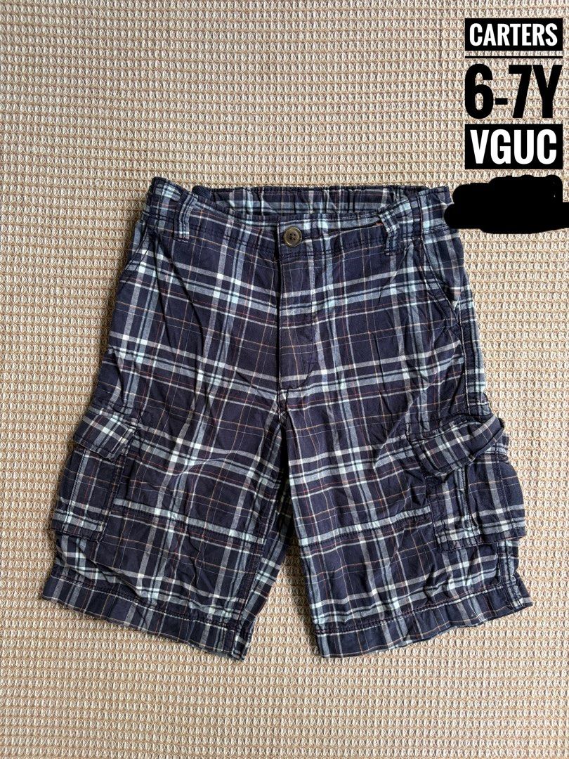 Carters Plaid Cargo Shorts Size 6 (Category: Babies & Kids Fashion) located in San Juan, La Union. Submitted by jcmami_ (Listing ID 1463658504, Image 1). Description: - Navy blue plaid cargo shorts - Size 6 - Features convenient side pockets - Ideal for everyday wear - Offers a comfortable fit.