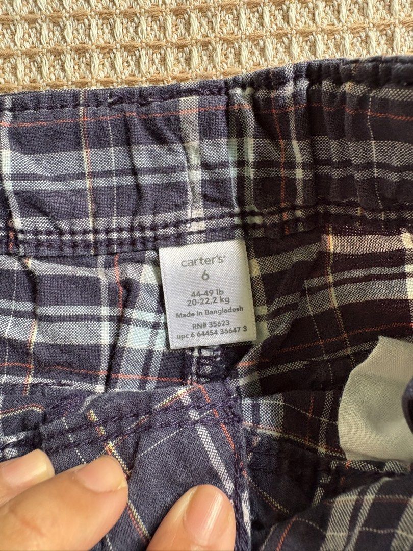 Carters Plaid Cargo Shorts Size 6 (Category: Babies & Kids Fashion) located in San Juan, La Union. Submitted by jcmami_ (Listing ID 1463658504, Image 2). Description: - Navy blue plaid cargo shorts - Size 6 - Features convenient side pockets - Ideal for everyday wear - Offers a comfortable fit.