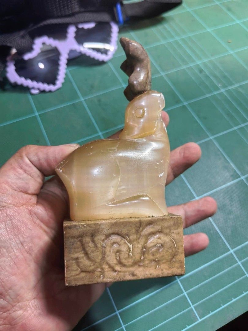 Carved Stone Seal Figurine (Category: Other Home Decor) located in Cebu City. Submitted by dudes_villanueva (Listing ID 1463656726, Image 2). Description: Carved Stone Seal Figurine 📌 Featuring a resting deer (or elk) atop a square base, resembling items carved from natural stone. 📌 Has visible scratches. Sold as is. 📌 Pricey sya pero benta Lang mura. L2.5xW2.5xH5.6 in.