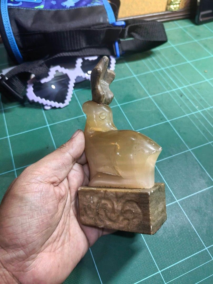 Carved Stone Seal Figurine (Category: Other Home Decor) located in Cebu City. Submitted by dudes_villanueva (Listing ID 1463656726, Image 3). Description: Carved Stone Seal Figurine 📌 Featuring a resting deer (or elk) atop a square base, resembling items carved from natural stone. 📌 Has visible scratches. Sold as is. 📌 Pricey sya pero benta Lang mura. L2.5xW2.5xH5.6 in.