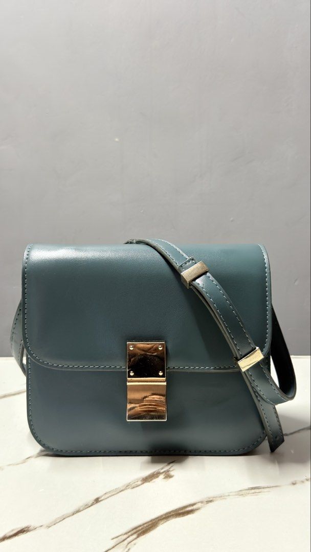Celine Crossbody Bag with Gold Clasp (Category: Cross-body Bags) located in Manila. Submitted by faye_preloved (Listing ID 1463650946, Image 2). Description: - Teal leather crossbody bag - Secure gold-tone metal clasp closure - Adjustable strap for comfortable wear - Simple and classic design - Perfect size for carrying your essentials - Versatile teal color complements various outfits.