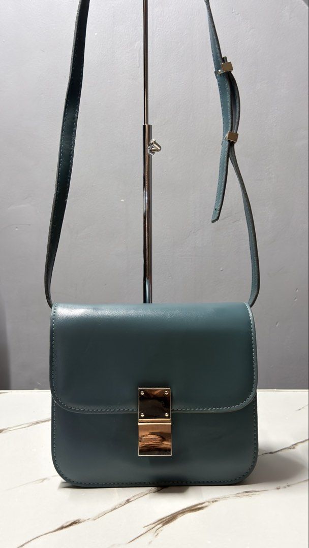 Celine Crossbody Bag with Gold Clasp (Category: Cross-body Bags) located in Manila. Submitted by faye_preloved (Listing ID 1463650946, Image 1). Description: - Teal leather crossbody bag - Secure gold-tone metal clasp closure - Adjustable strap for comfortable wear - Simple and classic design - Perfect size for carrying your essentials - Versatile teal color complements various outfits.