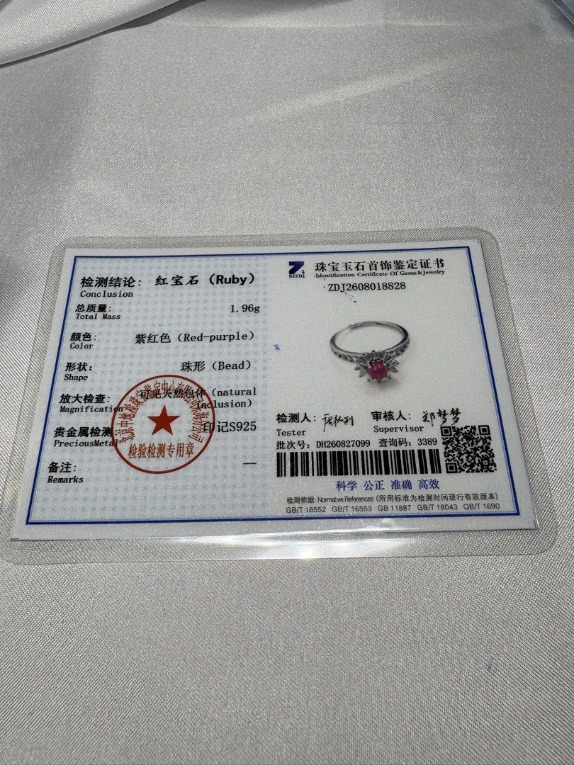 Certified Ruby Ring 💗 (Category: Rings) located in Singapore. Submitted by Discoverme (Listing ID 1463666453, Image 3). Description: Certified Ruby Ring 💗 A rich red-purple ruby takes centre stage, surrounded by sparkling zircon in a delicate starburst design. Set in S925 silver, it’s a lovely piece for everyday elegance or a special occasion. The accompanying certificate identifies the ruby and lists the ring’s total weight as 1.96 g. Personal