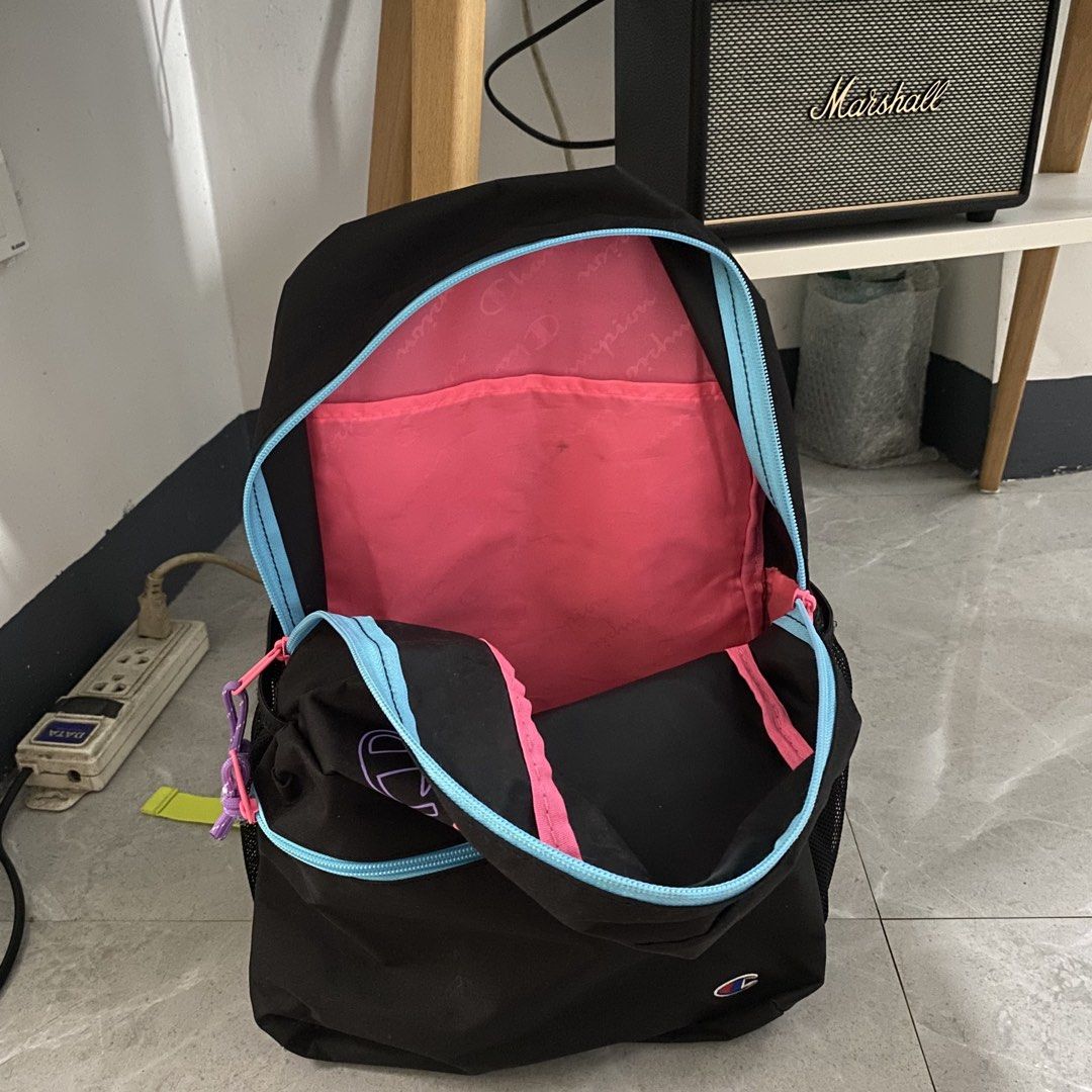 Champion Backpack Black Multi-Color Logo (Category: Backpacks) located in Taguig. Submitted by mixmix16 (Listing ID 1463658066, Image 3). Description: - Authentic Champion backpack - Eye-catching multi-color stacked logo on front - Vibrant blue zipper trim with pink pulls and purple cord details - Comfortable neon yellow padded shoulder straps - Vertical embroidered Champion logo on the back - Bright pink interior lining - Ample space for all you