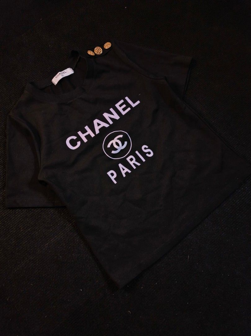 Chanel Paris Big Logo (Category: Shirts) located in San Fernando. Submitted by gaboo_asncn (Listing ID 1463711937, Image 1). Description: - Chanel Paris Big Logo - Size: Small (W16.5/L20) - Conditon: Excellent - Color Rate: 9.5/10 - No issue.