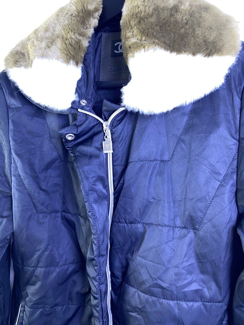 Chanel Puffer Jacket with Fur Collar (Category: Coats, Jackets and Outerwear) located in Manila. Submitted by declutterpromax (Listing ID 1463624857, Image 2). Description: - Chanel navy blue puffer jacket - Features a removable brown and white fur collar - Stylish quilted design with silver zipper details - Expertly crafted in France - Please check photos for small marks on the front.