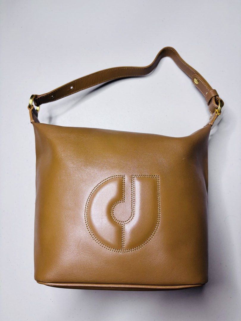 Charles Jourdan Brown Leather Shoulder Bag (Category: Shoulder Bags) located in Manila. Submitted by nicolesal (Listing ID 1463654745, Image 1). Description: - Genuine brown leather shoulder bag from Charles Jourdan. - Signature Charles Jourdan logo embossed on the front. - Convenient zippered pocket on the back. - Interior lining features repeating brand name print. - Bag is clean inside and out. - Perfect for everyday use, a timeless classic. O