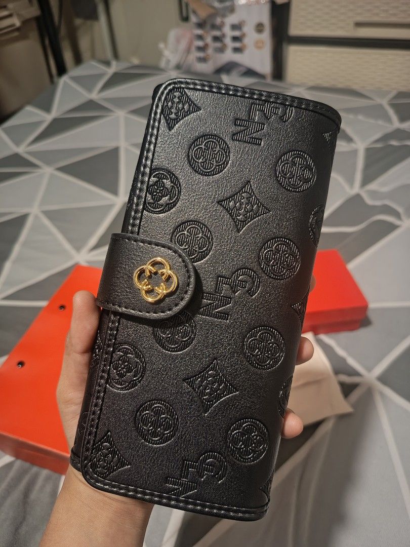 CLN Black Embossed Monogram Wallet with Pouch and Box (Category: Wallets & Card holders) located in Quezon City. Submitted by zai091995 (Listing ID 1463686453, Image 2). Description: - Black CLN wallet with embossed monogram pattern - Features gold hardware detail on the clasp - Comes with original dust pouch, CLN box, and shopping bag - Ideal for organizing your essentials.