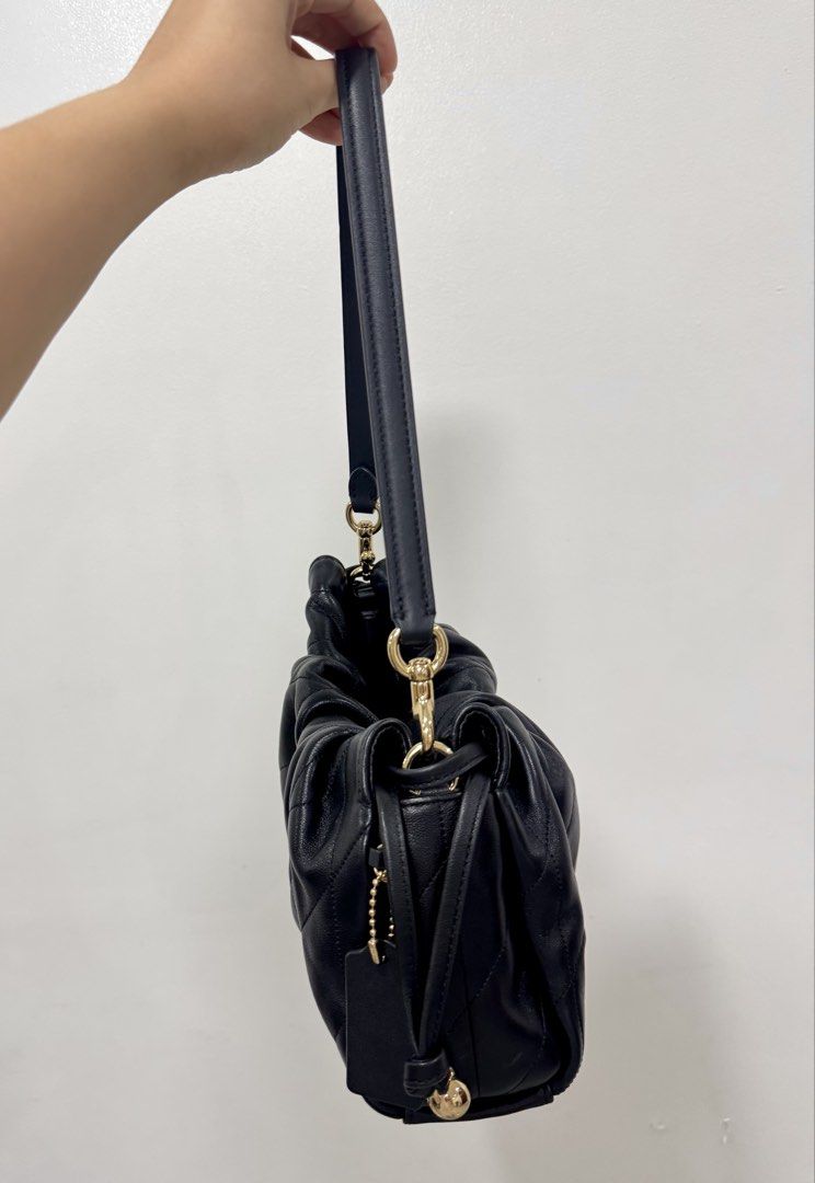 Coach Black Faye Quilted Leather Drawstring Shoulder Bag (Category: Luxury Bags & Wallets) located in Quezon City. Submitted by borahae888 (Listing ID 1463710033, Image 2). Description: - Brand: Coach - Material: Black quilted leather - Hardware: Gold tone - 2 Straps - 1 short and 1 long strap.