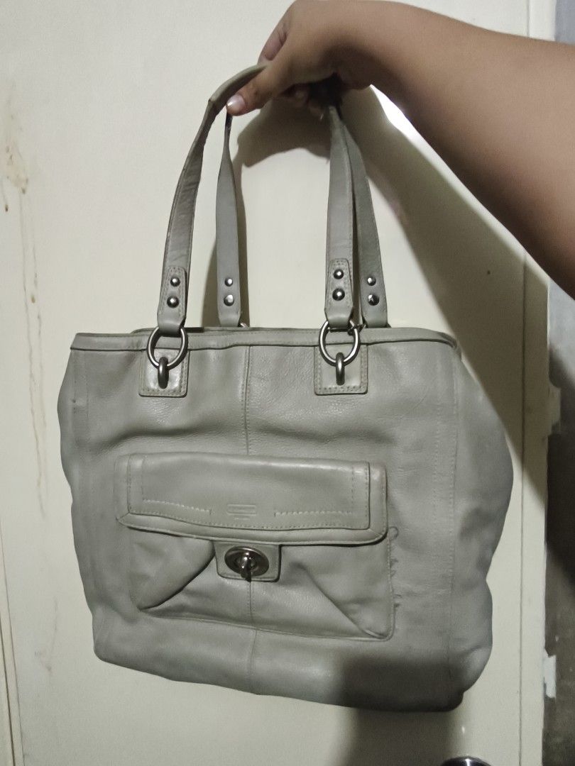Coach Leather Tote Bag (Category: Luxury Bags & Wallets) located in Plaridel. Submitted by julleyuuuh (Listing ID 1463592250, Image 1). Description: - Light grey Coach leather tote bag - Soft leather construction - Front pocket with secure turn-lock closure - Satin-lined interior - Note: Some fraying on the bottom edge of the front pocket - Ideal for carrying your daily essentials.