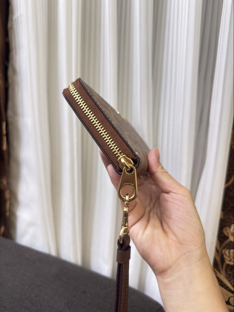 Coach Long Zip around Continental Wallet (Category: Wallets & Card holders) located in Manila. Submitted by manghobu (Listing ID 1462311917, Image 3). Description: BRANDNEW - Coach wristlet wallet in signature C pattern - Color: Brown and tan - Hardware: Gold - Closure: Zip-around - Features: Detachable wrist strap - Ample space for cards and cash - Perfect for everyday use or travel.