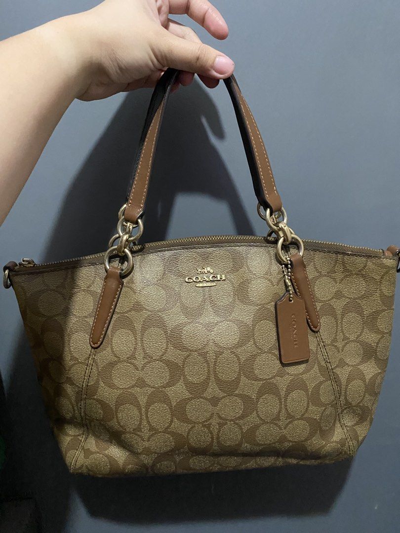 Coach Monogram Canvas Leather Trim Tote Bag (Category: Shoulder Bags) located in Batangas. Submitted by bagstolove3.0 (Listing ID 1463688265, Image 2). Description: - Coach monogram tote bag - Classic brown and tan signature 'C' pattern - Genuine leather trim and handles - Elegant gold hardware details - Secure zipper closure - Comes with original Coach hangtag - Perfect everyday companion - No sling.