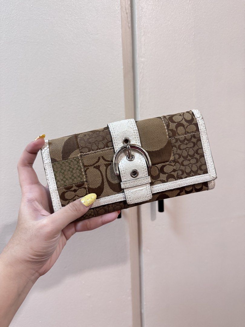 FIXED PRICE Coach Patchwork Long Wallet (Category: Wallets & Card holders) located in Manila. Submitted by livelaughlovejay (Listing ID 1463684686, Image 1). Description: - Authentic Coach wallet - Signature C monogram pattern - Unique brown and tan patchwork design - White trim detail - Secure silver buckle closure - Spacious interior for cards and cash - A timeless Coach accessory.