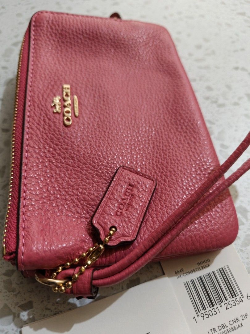 Coach Pink Leather Double Zip Wristlet (Category: Wallets & Card holders) located in Mandaluyong City. Submitted by TRES_MARIAS_SHOP (Listing ID 1463578382, Image 3). Description: - Bright pink Coach wristlet - Pebbled leather material - Double zip closure - Gold hardware - Detachable wrist strap - Interior card slots - Comes with original tags.