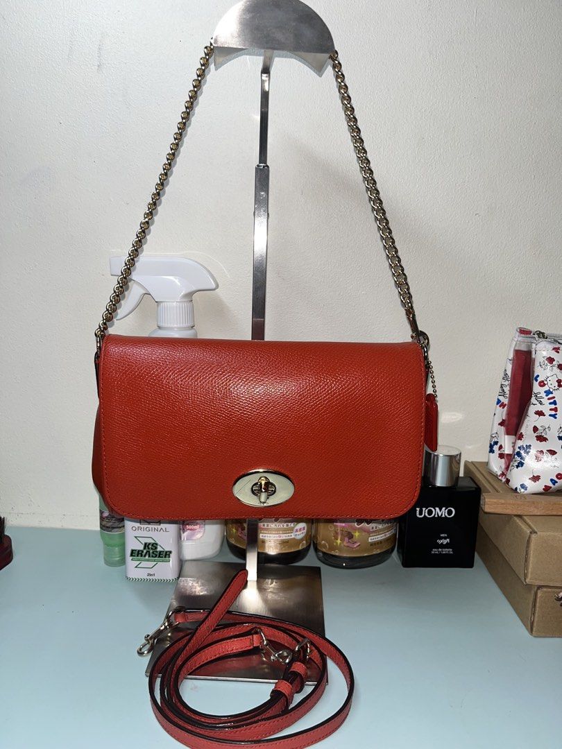 Coach Ruby in Orange Pebbled Leather Crossbody Bag with Chain Strap (Category: Cross-body Bags) located in Liloan. Submitted by sakurumifinds2809 (Listing ID 1463720764, Image 1). Description: - Coach orange pebbled leather crossbody bag -with care card and leather sling - Gold-tone hardware - Secure turn-lock closure - Detachable leather strap included - Detachable gold chain strap included - Comes with care instructions card - Versatile for eve