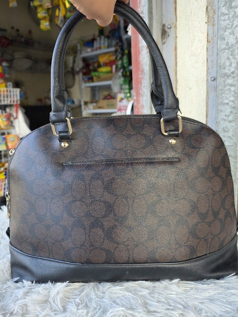 Coach Signature Monogram Dome Satchel Bag (Category: Purses & Pouches) located in Lemery. Submitted by venus23 (Listing ID 1463739645, Image 2). Description: - Coach monogram dome satchel - Classic brown and black colorway - Genuine leather trim and handles - Elegant gold hardware details - Secure zipper closure - Ideal for everyday use - Spacious interior for all your essentials.